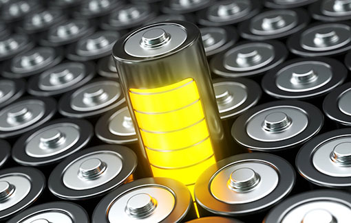 A yellow battery surrounded by other batteries.
