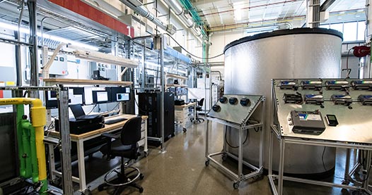 Workers in NREL's Energy Systems Integration Facility leveraging the chiller plant.