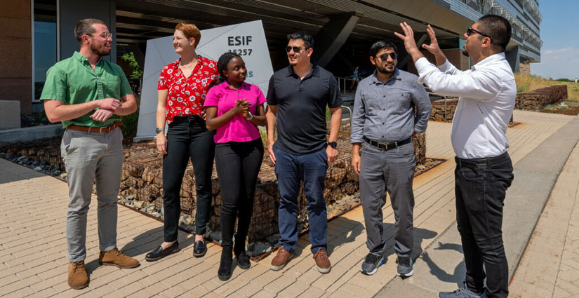 Six people stand in front of a modular building with a sign reading 'ESIF 15257'.