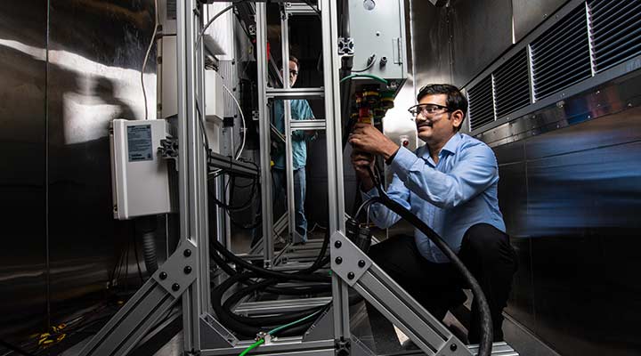 Photo of a researcher working on the residential battery test bed in the Energy Systems Integration Facility.