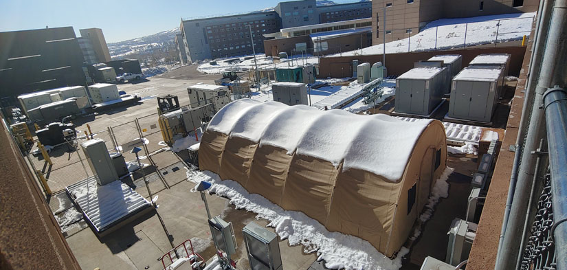A Quonset hut situated next to electric research infrastructure