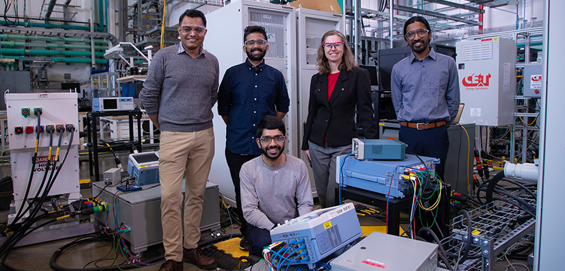 Group of researchers inside data computer laboratory.