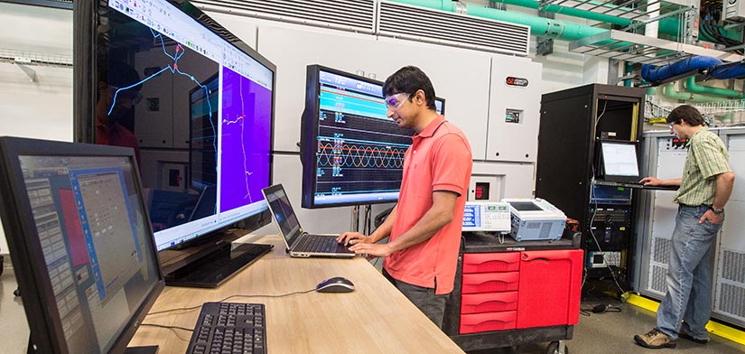 NREL researchers testing a power hardware-in-the-loop co-simulation.