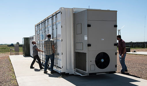 NREL researchers work with the Flex manufactured battery enclosure.