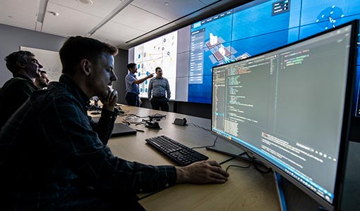 Photo of researchers working on a computer setup.