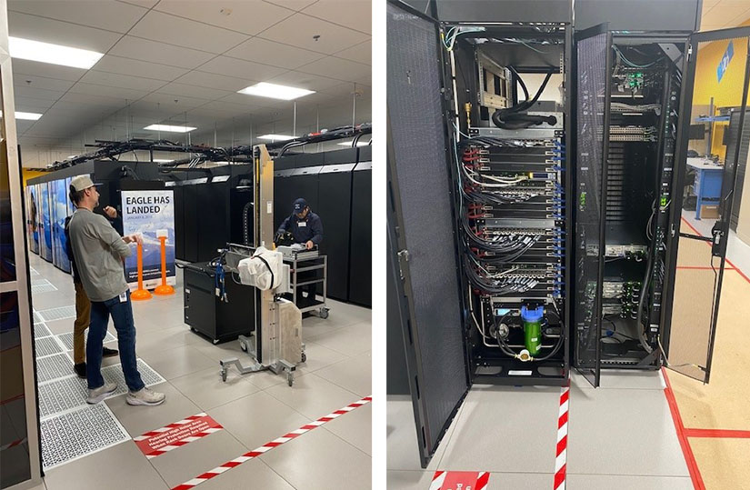 A photo of three people standing in a computer server room and computers internal parts.