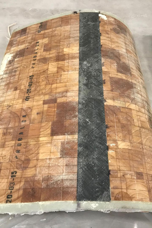 The finished product of the thermoplastic blade section manufacturing, made of balsa core and spar cap, a second layer of fiberglass, and Compoflex flow media.