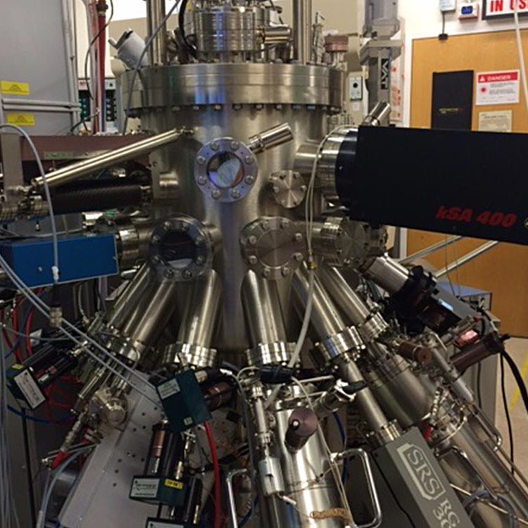 Photo of depositional chamber for molecular beam epitaxy at NREL showing various ports where the sample substrate and various elemental sources are introduced into the system. 
