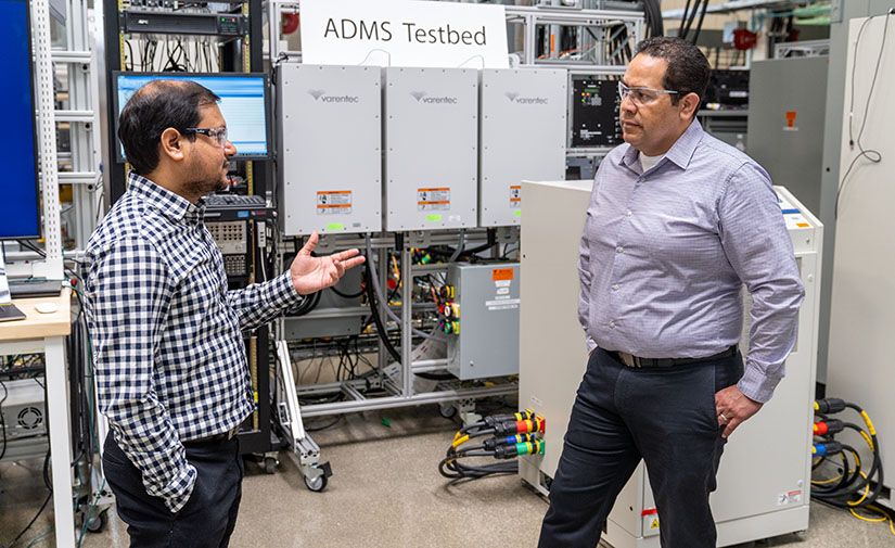 Two people talk in a lab.