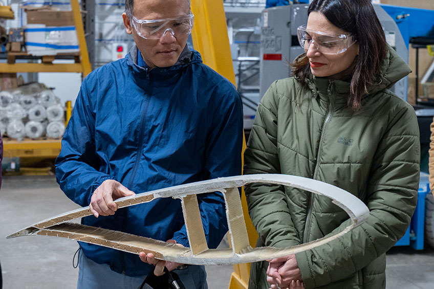 Two people examine an object.