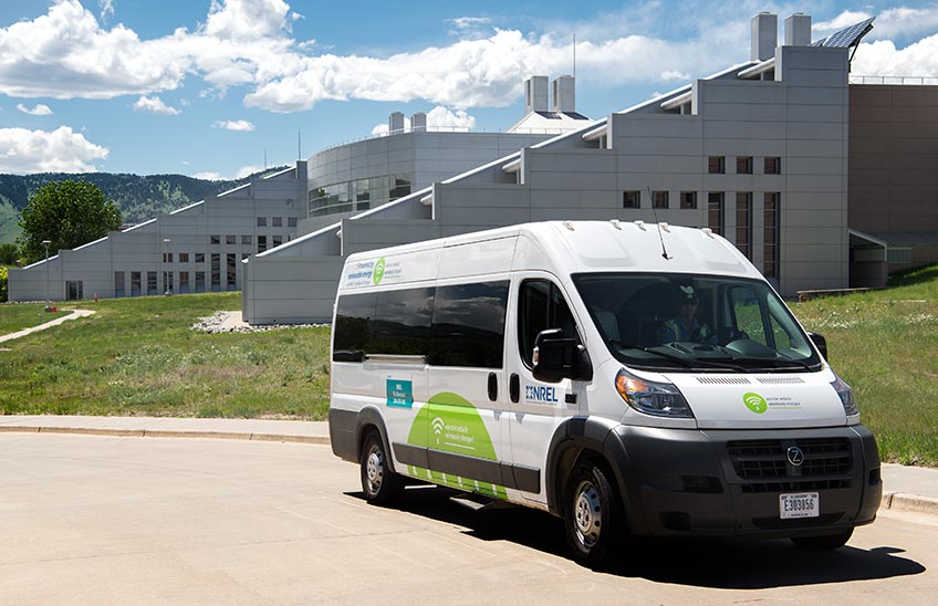 Photo of wirelessly charged electric vehicle parked in front of building.