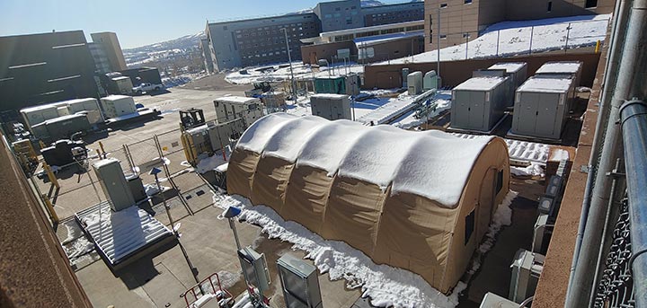 A Quonset hut situated next to electric research infrastructure