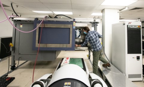 A man operating lab equipment. 