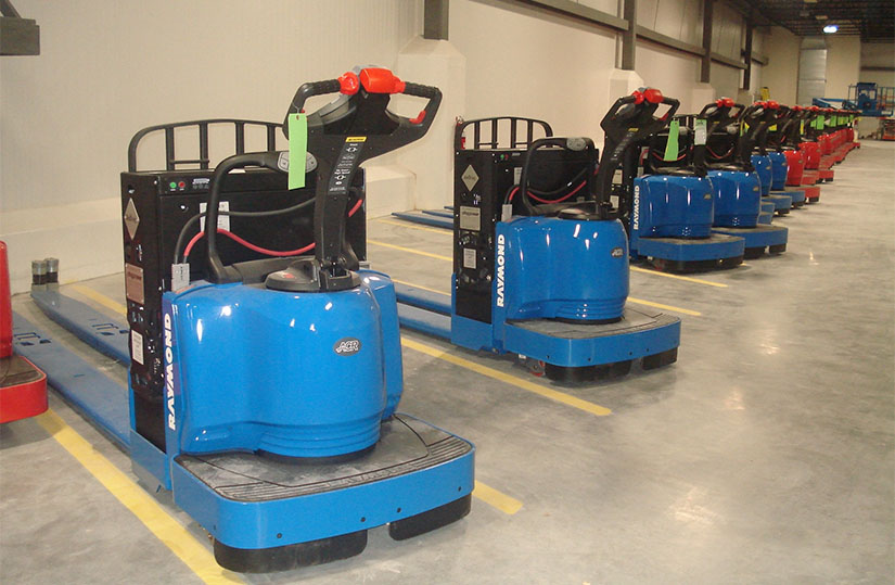 Forklifts lined up in a warehouse