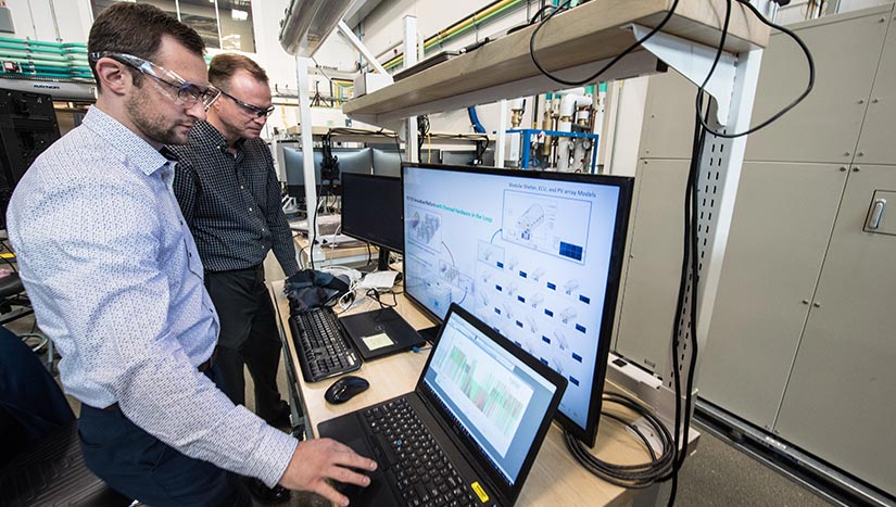 Photo of two researchers using a computer.