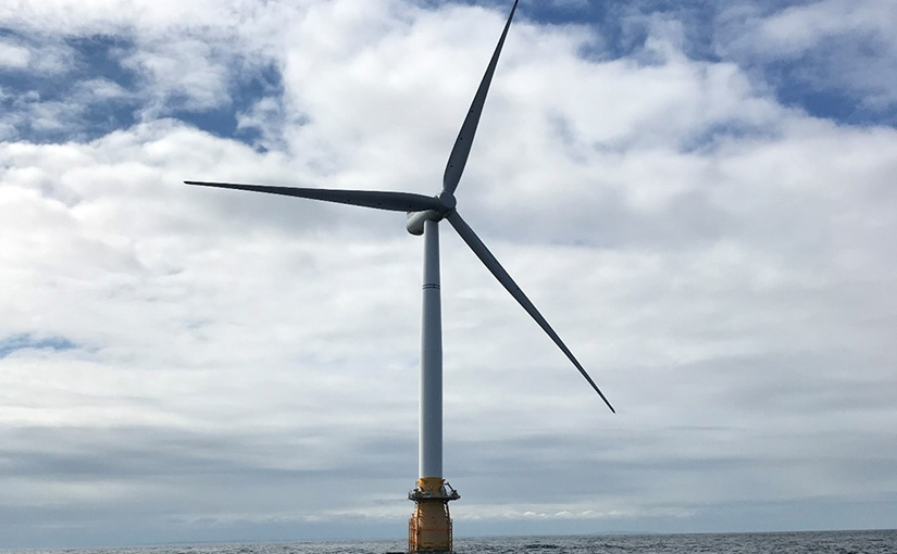 A wind turbine in a large body of water.