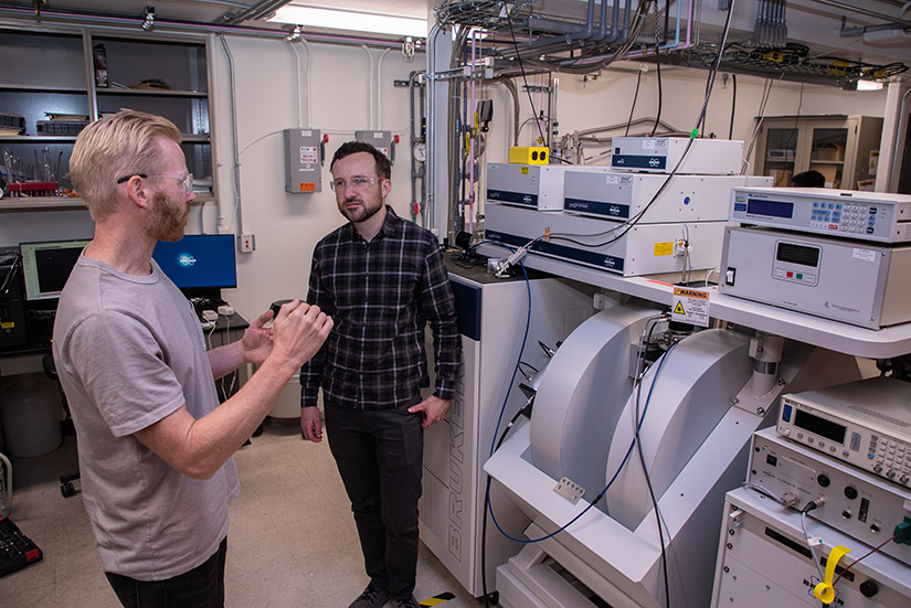 Two researchers stand in a lab.