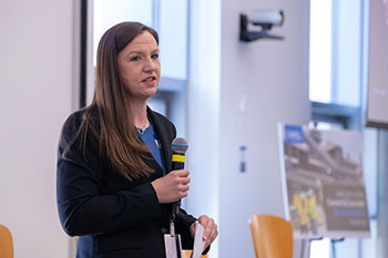 Aday speaking while holding a microphone