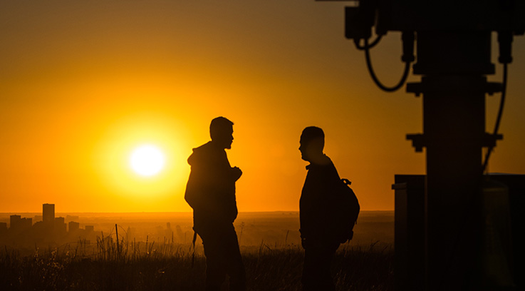 Researchers on a mesa at sunset