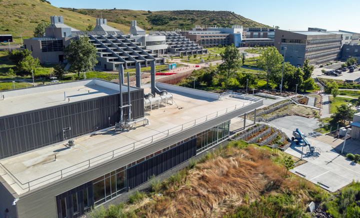 Buildings on a sprawling campus set against the mountains