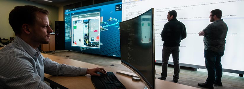 Researchers visualize a real-time cyberattack projected onto wall-size screens.