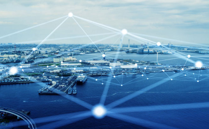 Lens view of a city next to an ocean with a connected technology web hovering above it.