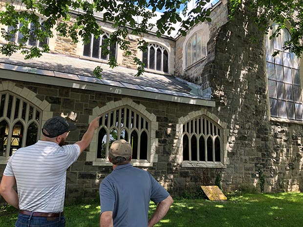 Two people looking at historic library being retrofitted to be more energy efficient.