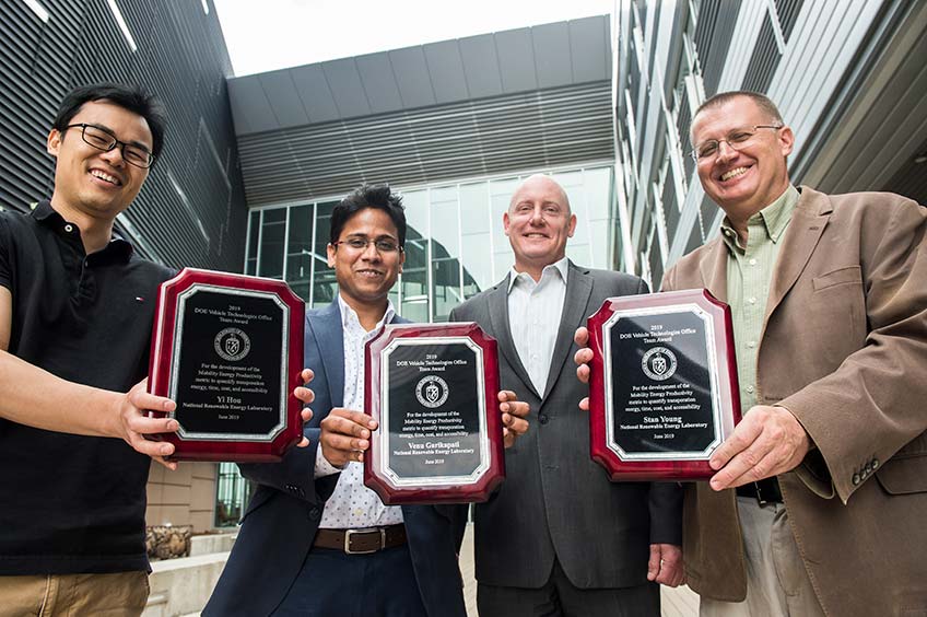 Researchers display their award plaques