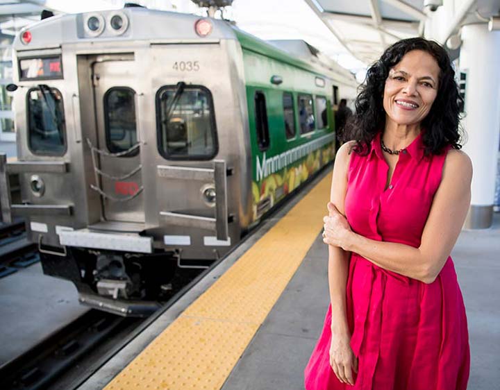 A researcher stands on the platform of a train station