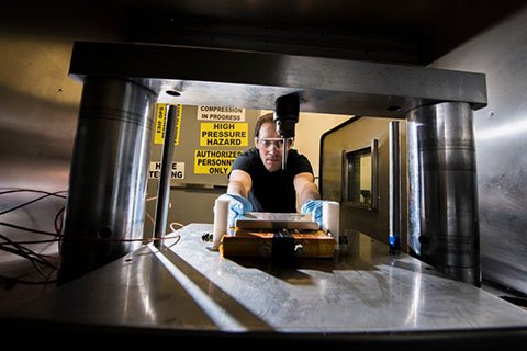 A researcher working with lab equipment. 