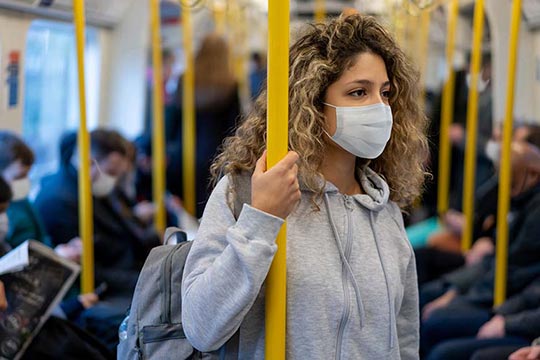 A person wearing a mask on public transportation.
