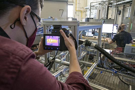 A researcher using a camera in a lab.