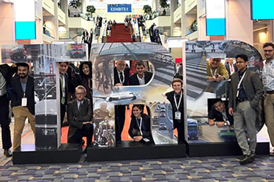 Photo of people standing near a large TRB sign.