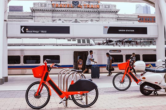 Shared bikes parked beside a train.