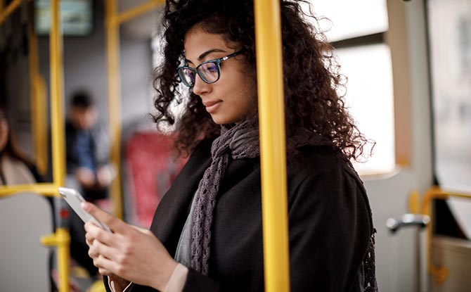 A woman looking at a cell phone.