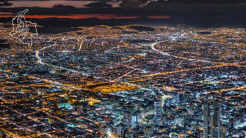 Photo of a large city at night with roads and many buildings.