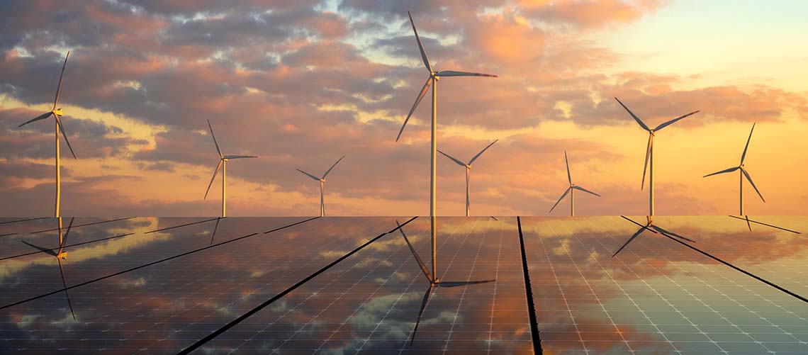 photovoltaic panels and wind turbines in the light of the rising sun