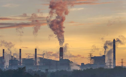 Power plant smoke stack emitting emissions into outside air.