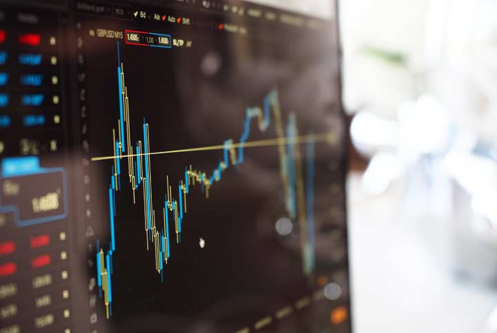 A back computer screen with data presented in color.