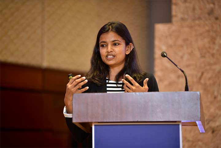 Carishma Gokhale-Welch speaking from a podium