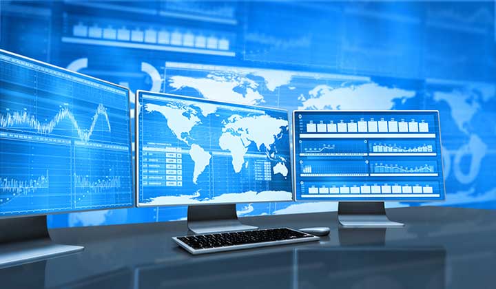 A stock photo of a desktop computer with figures and a map on the screen.