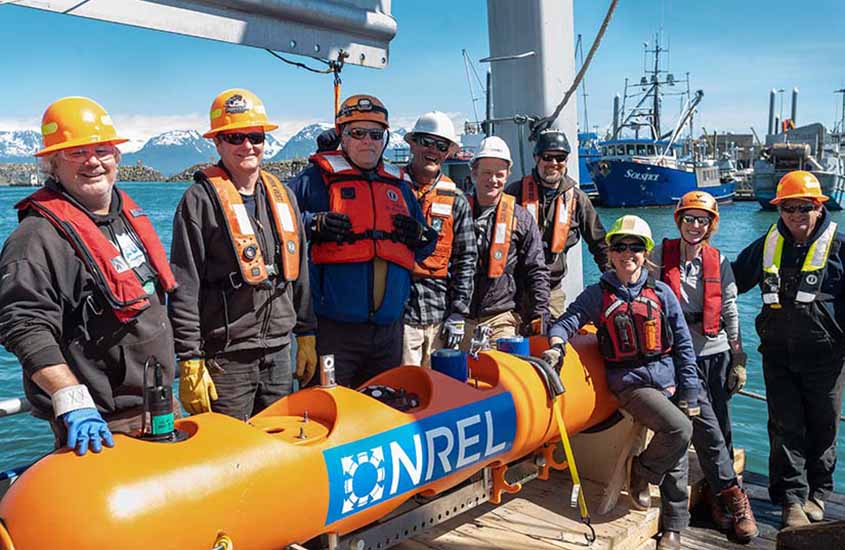 Researchers on a boat standing next to a mooring