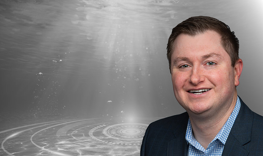 Aaron overlain on a black-and-white photo of underwater.