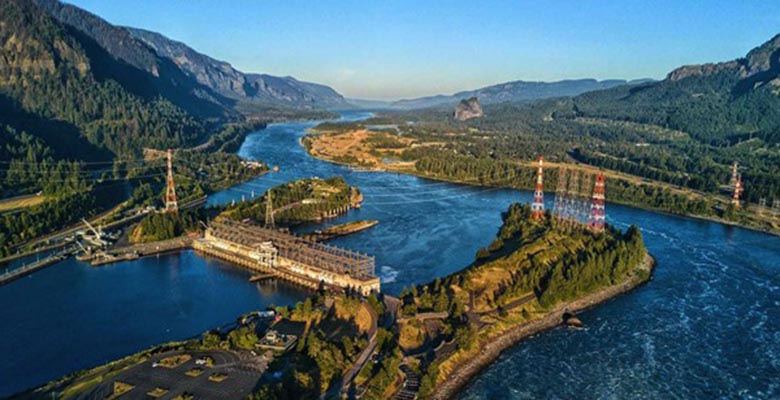 A hydropower plant and power distribution lines over a river.
