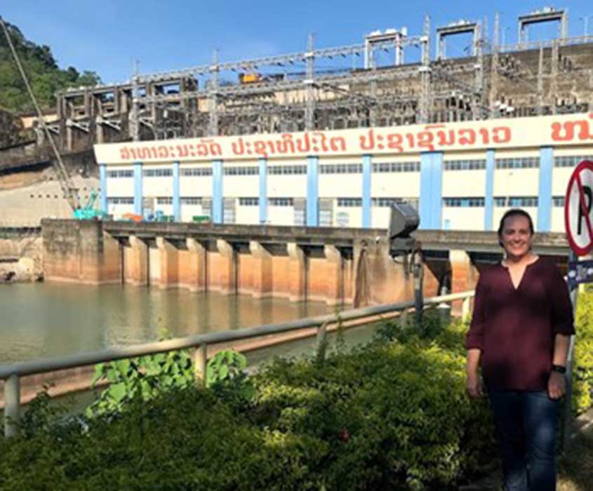 Sherry Stout in front of a dam